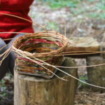 the final stages of weaving a plank basket.