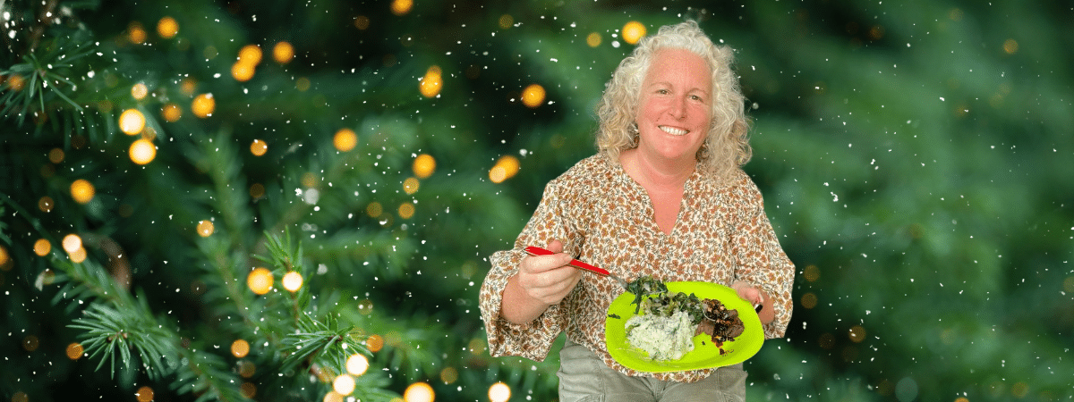 a perosn with huge smile a full plate of foraged food and a Christmas background 